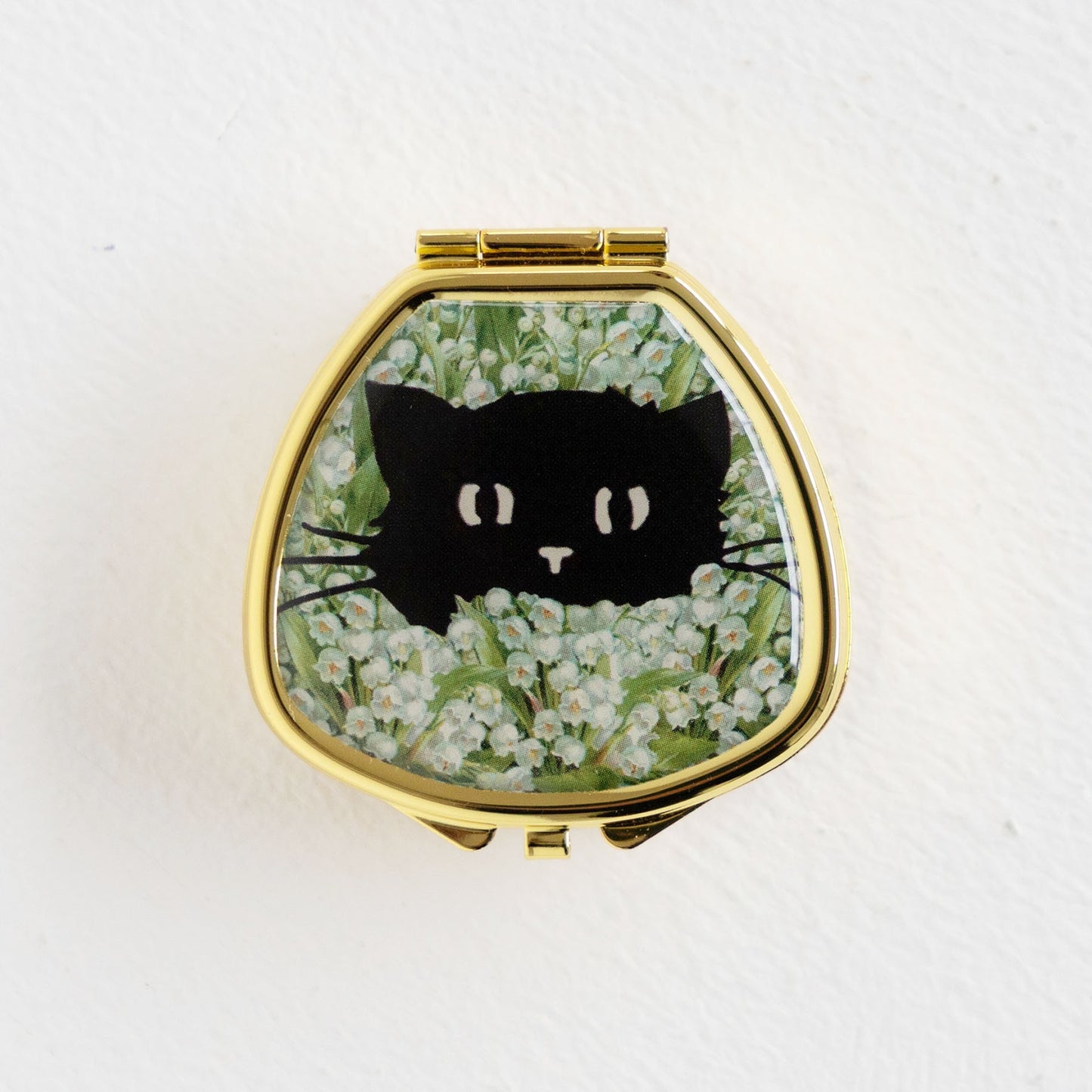 BLACK CAT IN LILY OF VALLEY